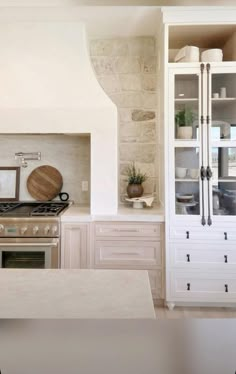 a kitchen with an oven, cabinets and counter tops in the middle of the room