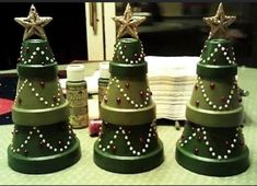 three green christmas trees sitting on top of a table