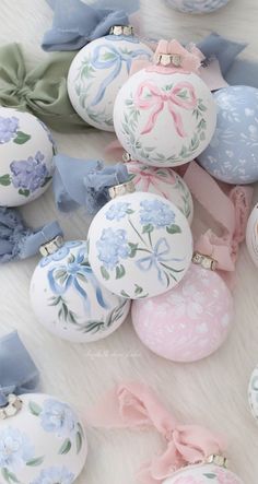 an assortment of decorated easter eggs with bows and bows on the top, all in pastel colors