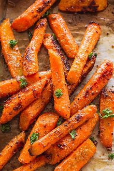 roasted carrots with herbs and seasoning on a baking sheet, ready to be eaten