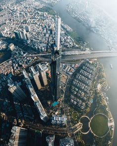 an aerial view of a large city with lots of tall buildings in the middle of it