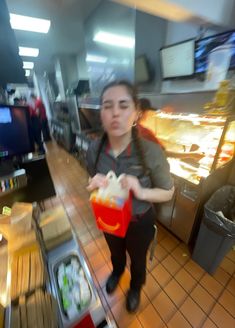 a blurry image of a woman carrying food