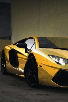 a yellow sports car parked in front of a building