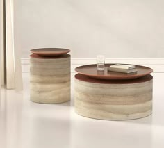 two round tables sitting next to each other on top of a white floor