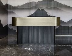 a black and white bathroom with mountains painted on the wall behind the sink is a stainless steel faucet