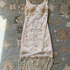 Worn Once Excellent Condition. Beautiful Stitching And Beadwork. Lined And It’s A Nice Beige /Nude Color. Has Pearl Beads. The Back Is Sexy With Straps Across. Pit To Pit The Dress Measures 15 Inches. The Length Is 32 Inches. And It Has A Side Zipper. Elegant Summer Flapper Dress With Beaded Fringe, Bohemian Hand Embellished Summer Dresses, Elegant Hand Embellished Beige Dress, Summer Bohemian Hand Embellished Dresses, Elegant Beige Hand Embellished Dress, Fitted Sleeveless Dress With Beaded Fringe, Fitted Beaded Fringe Flapper Dress For Summer, Spring Fitted Dress With Beaded Fringe, Beaded Fringe Fitted Flapper Dress For Wedding