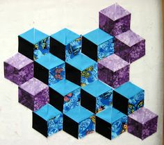 an art piece made out of paper with blue and purple cubes on the side