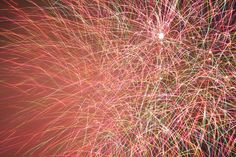 colorful fireworks exploding in the night sky with long exposure and blurry light effects photo