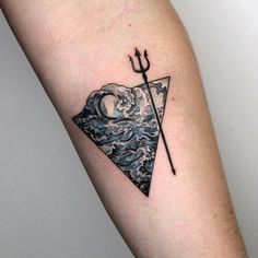 a tattoo with an image of a triangle and a spear on the side of the arm