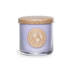 a small glass candle with a wooden lid on a white background the candle is light purple and has a gold logo