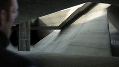 a man riding a skateboard up the side of a ramp in a parking garage