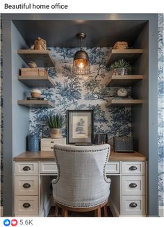 a home office with blue and white wallpaper