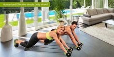 a man and woman doing push ups in front of a living room with large windows