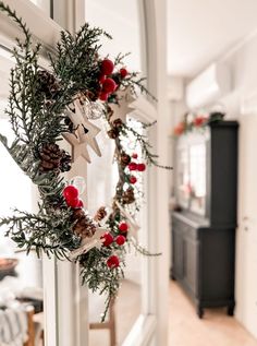 a christmas wreath is hanging on the front door