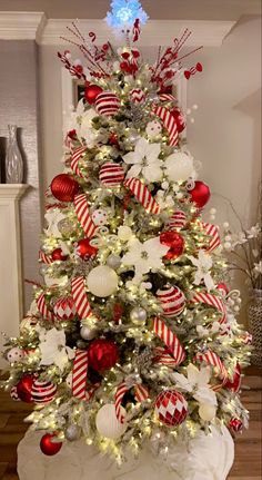 a decorated christmas tree with red and white ornaments