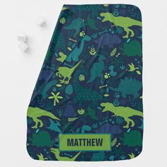 a blue and green dinosaur blanket with name on it