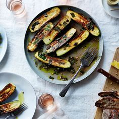 grilled zucchini on a plate next to other food