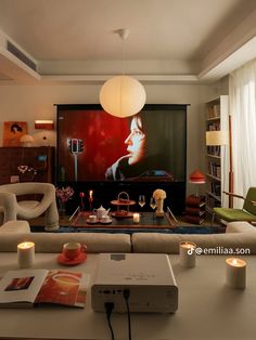 a living room filled with furniture and a flat screen tv sitting on top of a wall