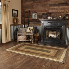 a living room filled with furniture and a fire place next to a wall covered in wood planks