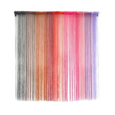 multicolored fringes are hanging on a wall in the shape of a rainbow