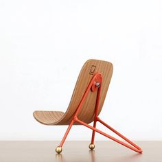 an orange chair sitting on top of a wooden table