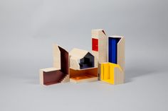 a wooden model with different colored sections on it's sides and an opening in the middle