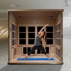 a woman practices yoga in an indoor sauna