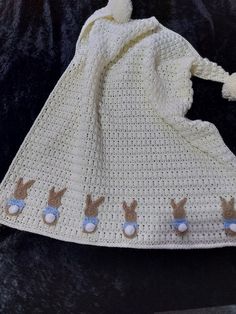 a crocheted baby blanket with deers on it