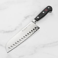 a large knife sitting on top of a white counter