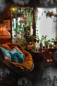 a room filled with lots of plants and candles