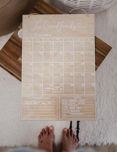 a person standing next to a wooden calendar