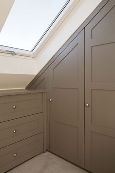 an empty closet with drawers and a skylight