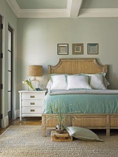 a bedroom with a bed, nightstands and pictures on the wall