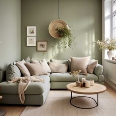 a living room with green walls and white rugs on the floor next to a couch