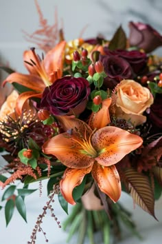 a vase filled with lots of flowers on top of a table