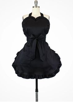 a black dress on a mannequin with a bow at the waist and back