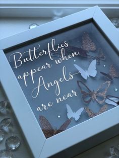 there is a glass box with some butterflies in it and the words, butterflies appear when angels are near