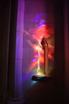 the light is shining brightly through the stained glass window