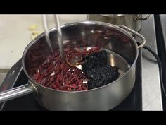 a pot full of food sitting on top of a stove next to a burner