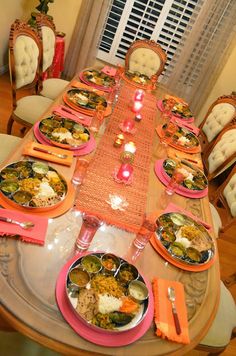 the table is set with many plates and silverware