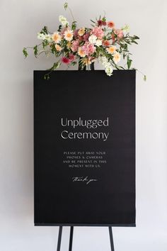 a sign with flowers on it that says, welcome to the wedding of lauren and bradley