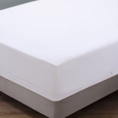 a close up view of a white bed with no sheets on the top and bottom