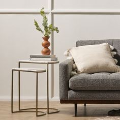 a living room with a couch, chair and side table