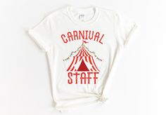 a white t - shirt with the words carnival staff printed on it and a circus tent