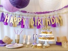 a birthday party with purple and gold decorations