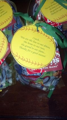 baseball themed candy wrapped in plastic wrapper and tied with green ribbon on top of wooden table