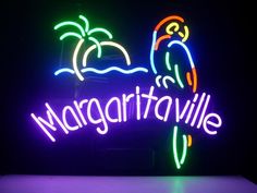 the margaritaville sign is lit up with neon lights and has a parrot on it