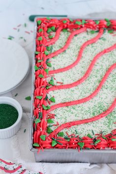 a cake with green and red frosting on it