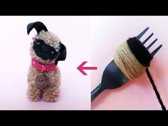 a small dog is next to a hairbrush with yarn on it's head