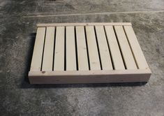 a wooden floor grate laying on the ground